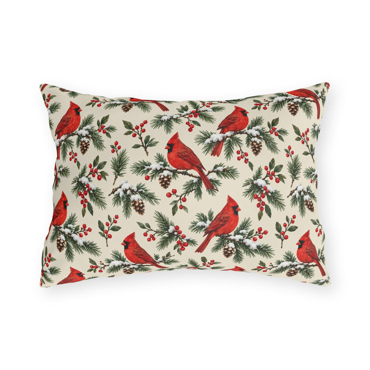 Christmas cardinal outdoor lumbar pillow with red cardinals, snowy pine sprigs, pinecones and red berries on soft cream