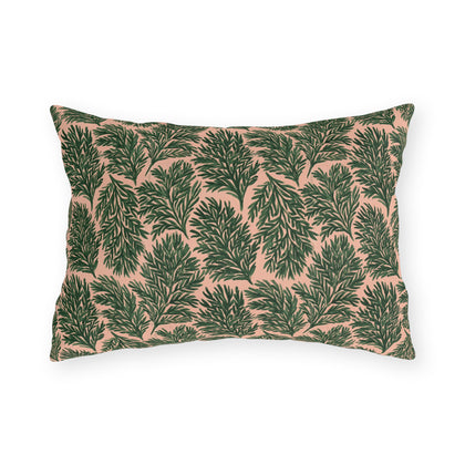 Dark green pine sprigs on blush peach outdoor lumbar pillow