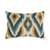 Boho outdoor lumbar pillow with an ikat diamond pattern in navy, slate blue and mustard on cream