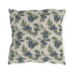 Blue juniper berries and green foliage on cream outdoor pillow