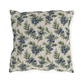 Blue juniper berries and green foliage on cream outdoor pillow