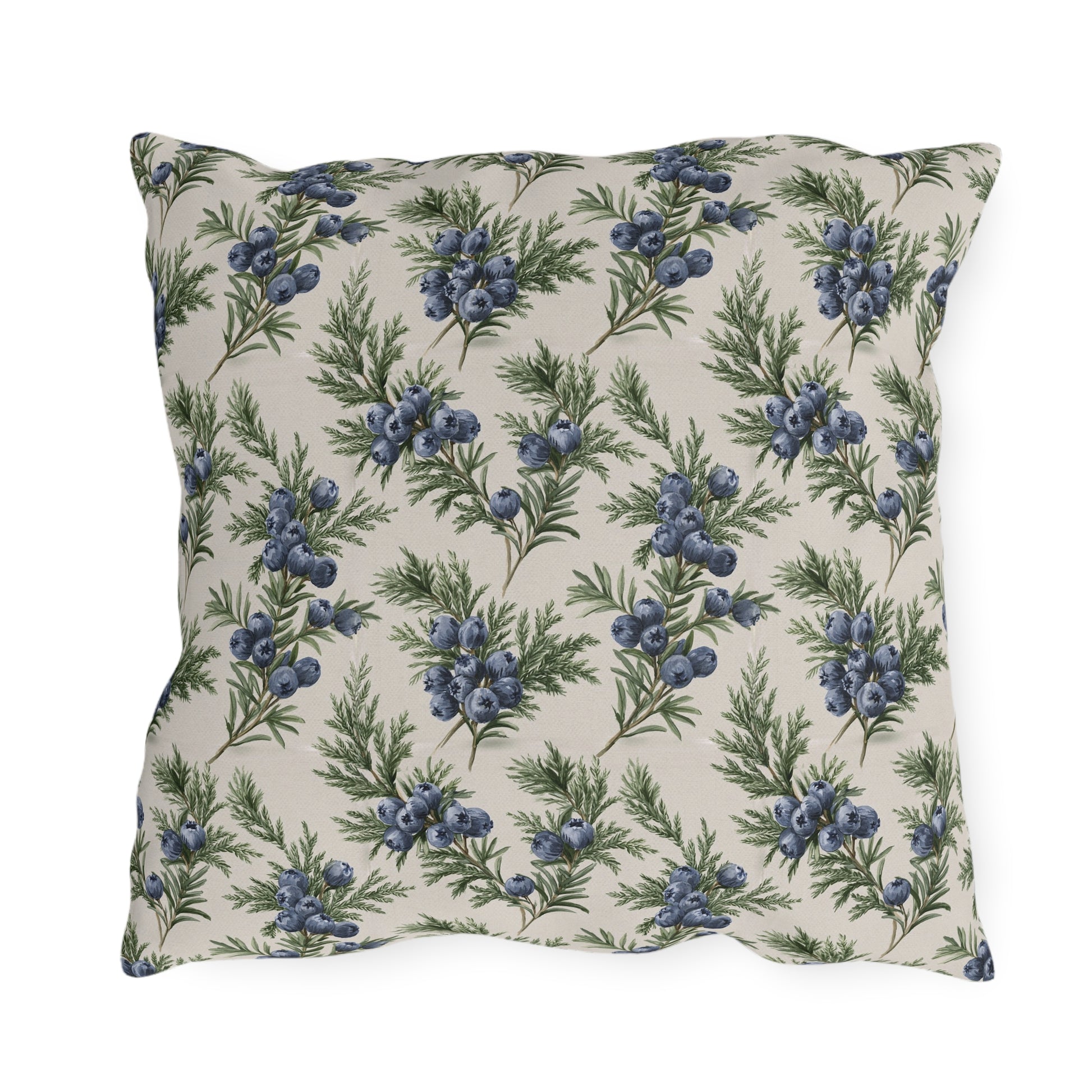 Blue juniper berries and green foliage on cream outdoor pillow