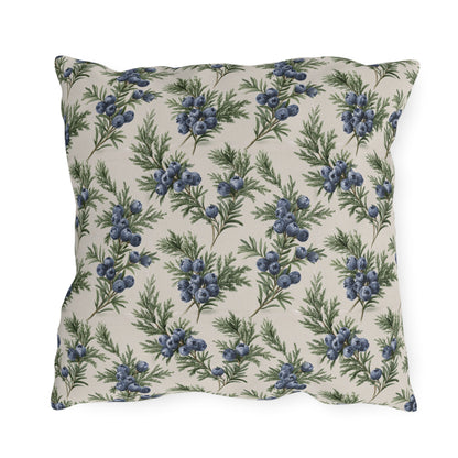 Blue juniper berries and green foliage on cream outdoor pillow