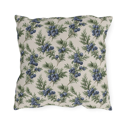 Blue juniper berries and green foliage on cream outdoor pillow