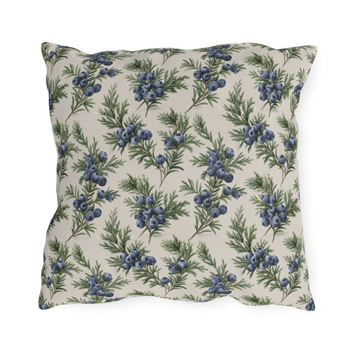 Blue juniper berries and green foliage on cream outdoor pillow