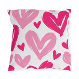 Hot pink outdoor pillow with large painted hearts in hot pink and soft pink on white