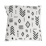 Black and white mudcloth outdoor pillow with hand-drawn arrows, diamonds and dashes in charcoal on warm white