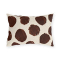 Modern polka dot outdoor lumbar pillow with large hand painted chocolate brown dots on cream