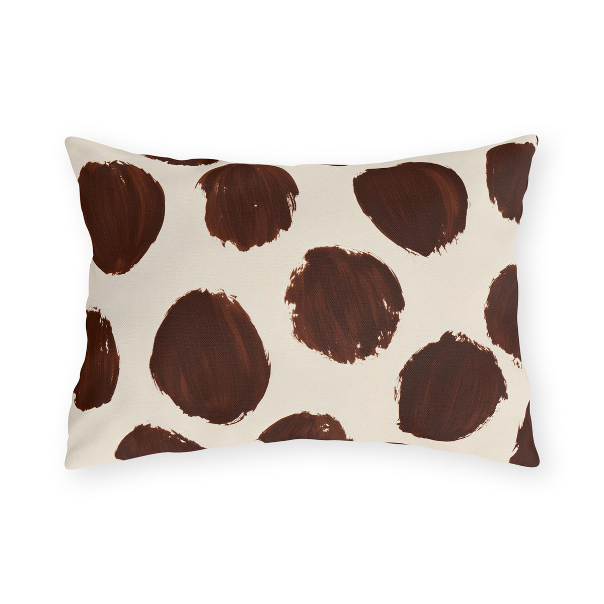 Modern polka dot outdoor lumbar pillow with large hand painted chocolate brown dots on cream