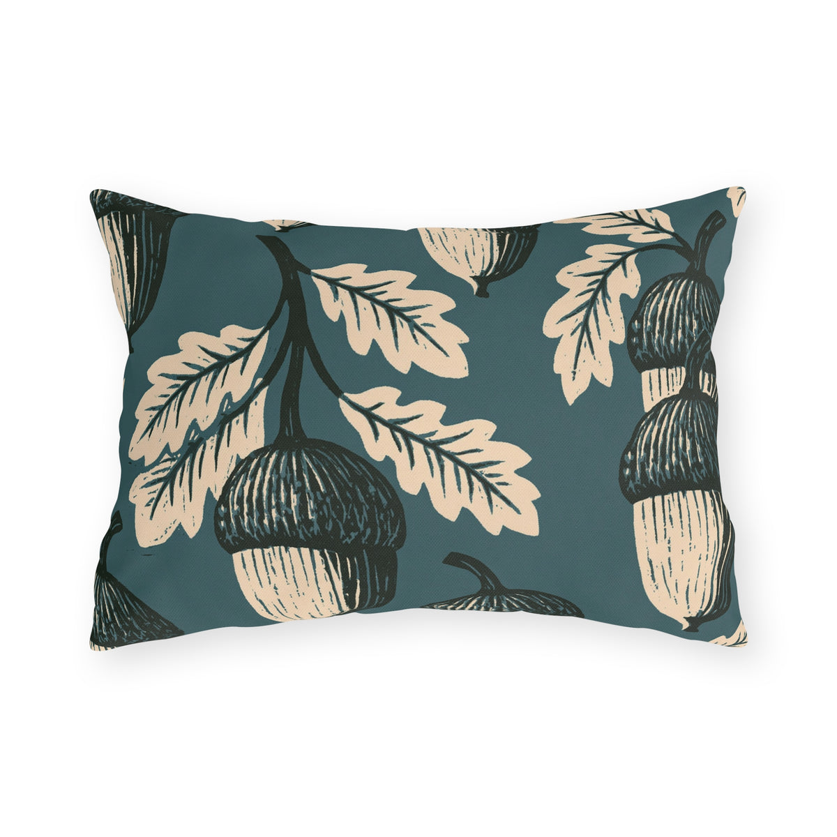 Cream and black block print acorns and oak leaves on a deep teal outdoor lumbar pillow