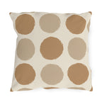 Neutral polka dot outdoor pillow with large camel and sand dots on cream