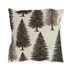 Large ink-sketched pine trees on a cream outdoor pillow