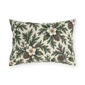 White winter roses, cedar, pinecones and white berries on a cream outdoor lumbar pillow