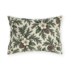 White winter roses, cedar, pinecones and white berries on a cream outdoor lumbar pillow