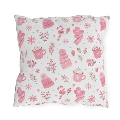 Pink beanies, mittens, cocoa mugs and snowflakes on white outdoor pillow