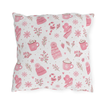 Pink beanies, mittens, cocoa mugs and snowflakes on white outdoor pillow