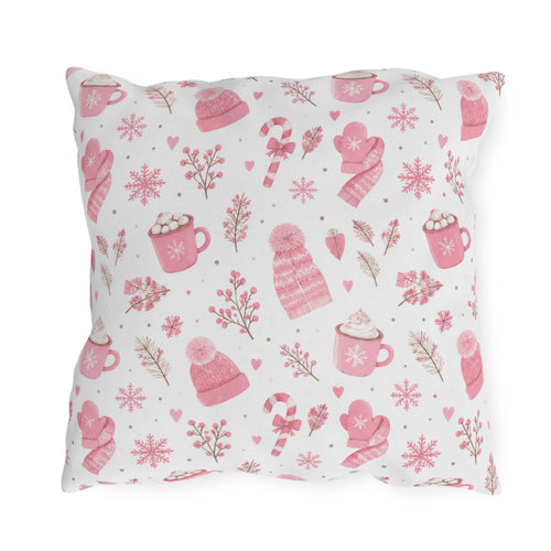 Pink beanies, mittens, cocoa mugs and snowflakes on white outdoor pillow