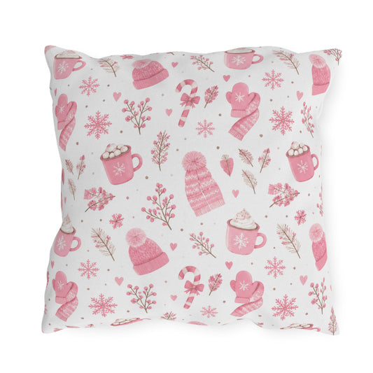 Pink beanies, mittens, cocoa mugs and snowflakes on white outdoor pillow
