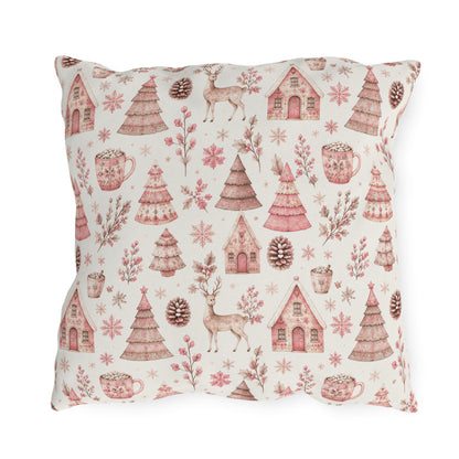 Pink patterned Christmas trees, deer, gingerbread houses and cocoa mugs on cream outdoor pillow