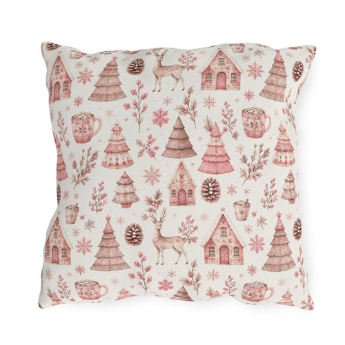Pink patterned Christmas trees, deer, gingerbread houses and cocoa mugs on cream outdoor pillow