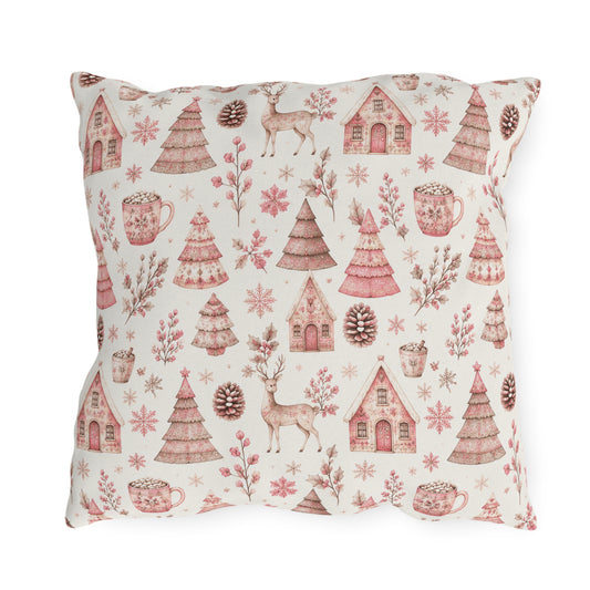 Pink patterned Christmas trees, deer, gingerbread houses and cocoa mugs on cream outdoor pillow