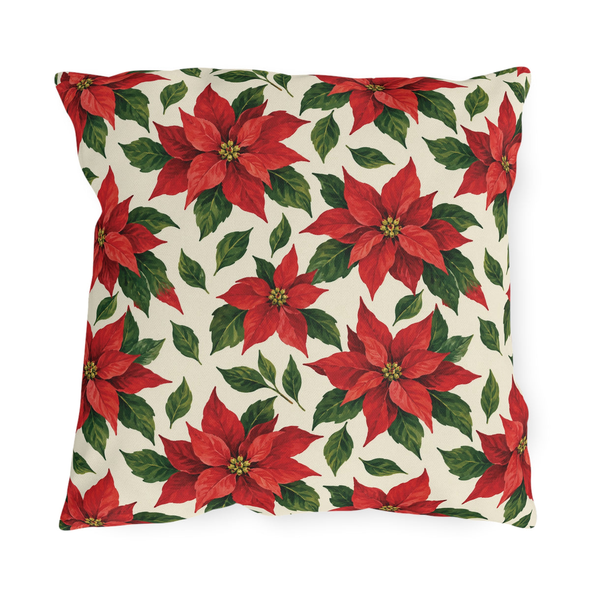 Christmas poinsettia outdoor pillow with red poinsettia blooms, golden centers and green leaves on warm cream