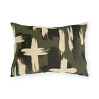 Cream and black brushstroke crosses on an olive green outdoor lumbar pillow