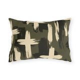 Cream and black brushstroke crosses on an olive green outdoor lumbar pillow