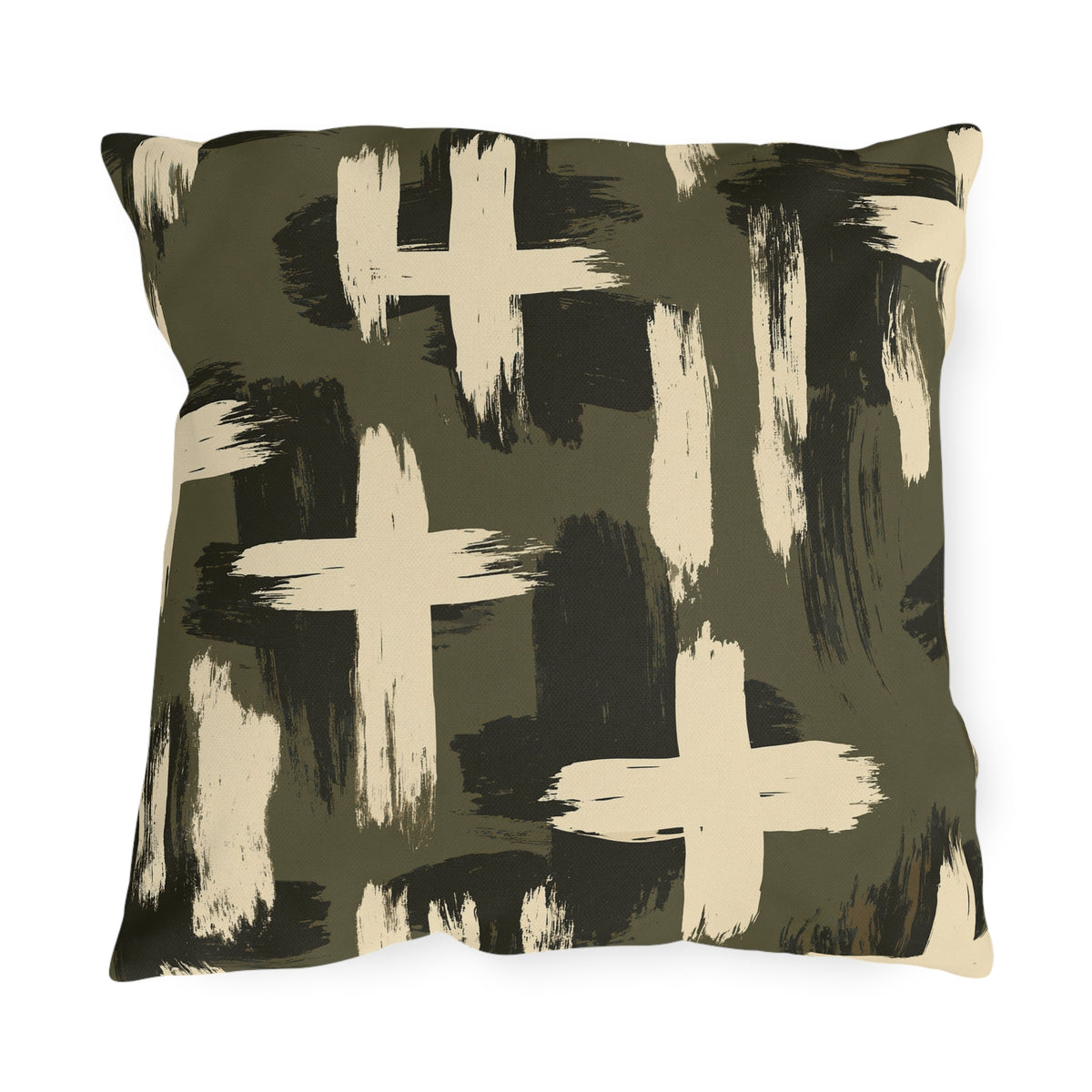 Cream and black brushstroke crosses on an olive green outdoor pillow