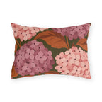 Pink hydrangea outdoor lumbar pillow with blush and rose hydrangea blooms and rust leaves on olive green