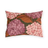 Pink hydrangea outdoor lumbar pillow with blush and rose hydrangea blooms and rust leaves on olive green