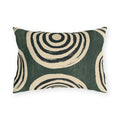 Black and cream concentric rings on a mottled forest green outdoor lumbar pillow