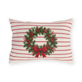Christmas wreath outdoor lumbar pillow with a pine and berry wreath and red bow on cream with cranberry pinstripes