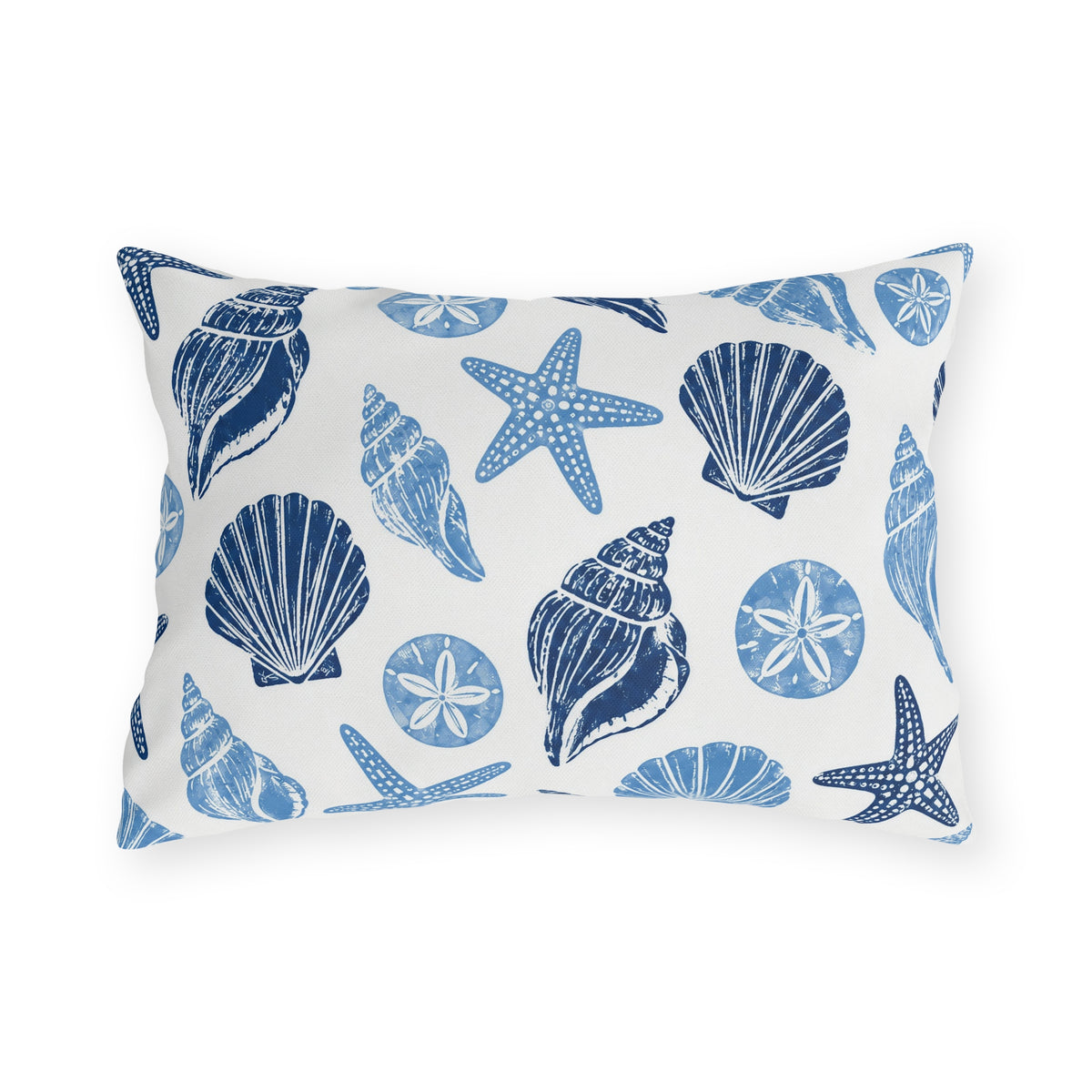 Coastal outdoor lumbar pillow with navy and sky blue seashells, starfish and sand dollars on white