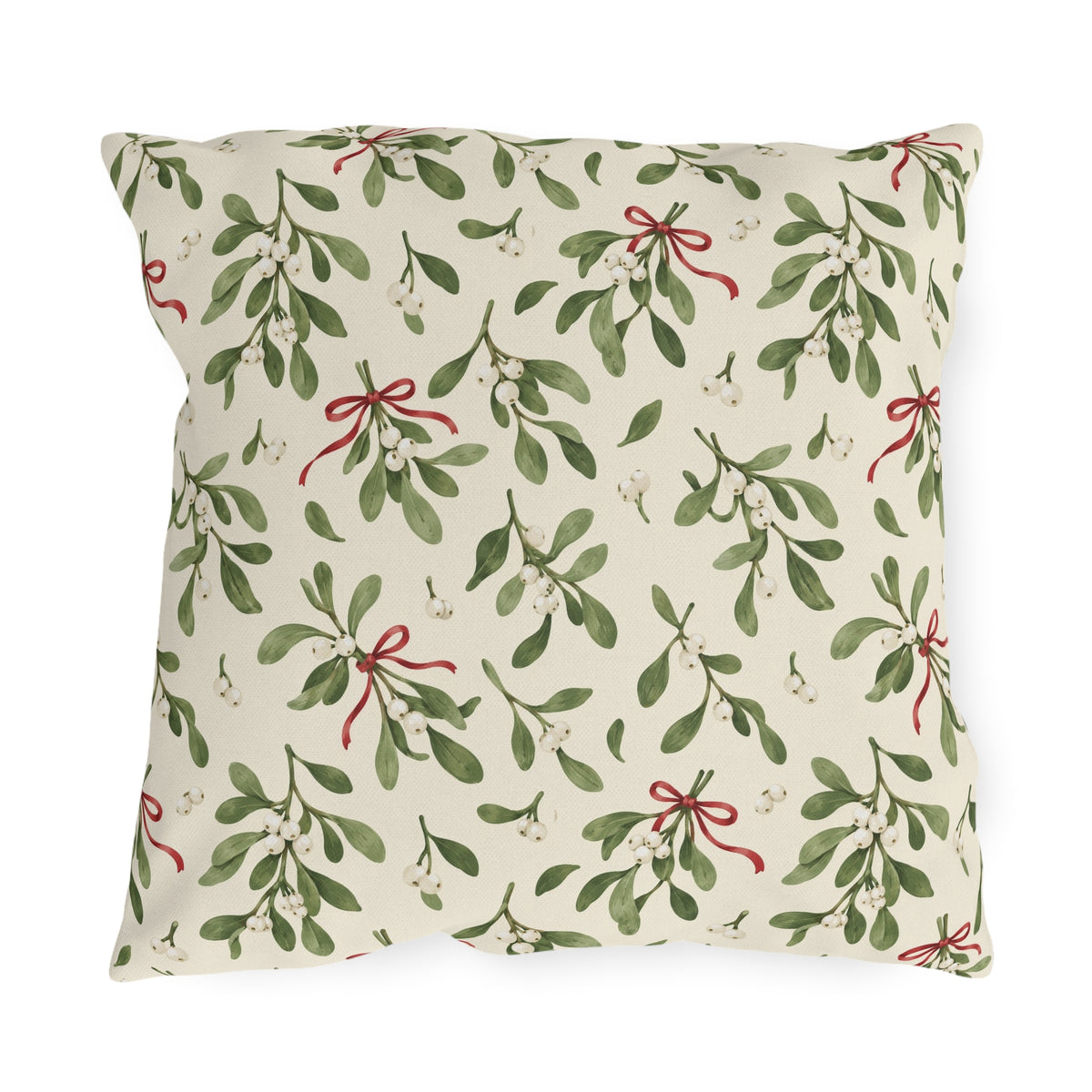 Christmas mistletoe outdoor pillow with sage green sprigs, white berries and thin red bows on warm cream