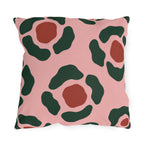 Modern outdoor pillow with forest green and rust red abstract rosettes on blush pink