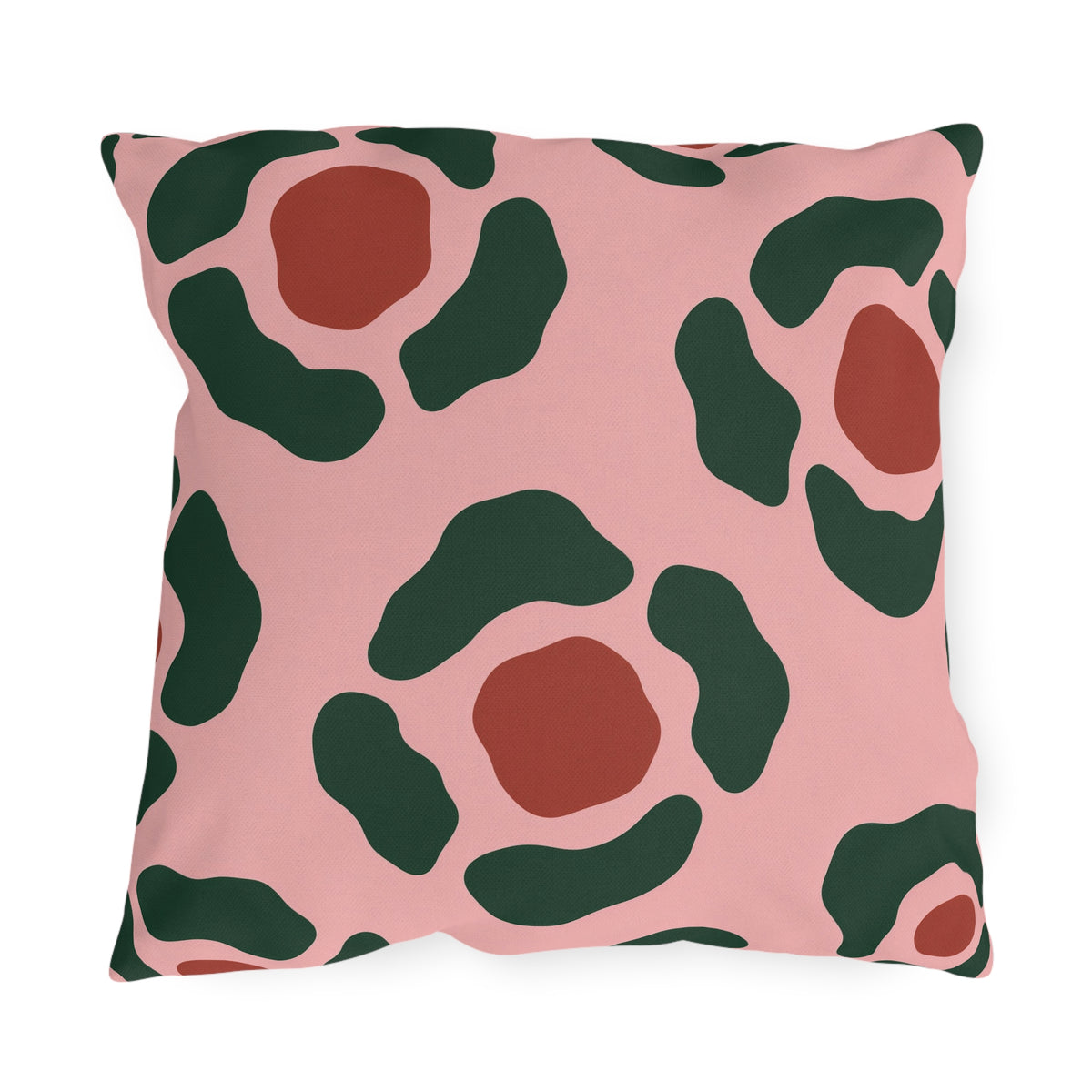 Modern outdoor pillow with forest green and rust red abstract rosettes on blush pink