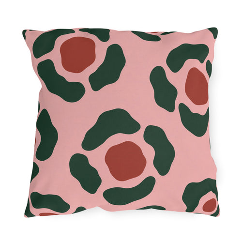Modern outdoor pillow with forest green and rust red abstract rosettes on blush pink