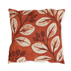 Cream leaves and dark rosehips block printed on a burnt terracotta outdoor pillow