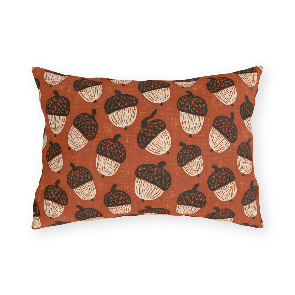 Block-printed cream and dark brown acorns on rust orange outdoor lumbar pillow