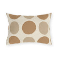 Neutral polka dot outdoor lumbar pillow with large camel and sand dots on cream