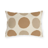 Neutral polka dot outdoor lumbar pillow with large camel and sand dots on cream
