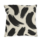 Black and cream outdoor pillow with loose abstract black brush strokes