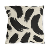 Black and cream outdoor pillow with loose abstract black brush strokes