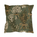 Rosemary, lavender and thyme bundles tied with twine on a sage green outdoor pillow