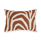 Modern outdoor lumbar pillow with bold rust zebra stripes on cream
