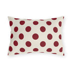 Merlot polka dot outdoor lumbar pillow with large deep wine purple dots on cream