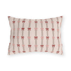 Pink and red ribbon bows on striped blush outdoor lumbar pillow
