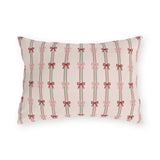 Pink and red ribbon bows on striped blush outdoor lumbar pillow