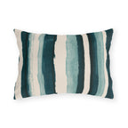 Teal and cream painted stripes on an outdoor lumbar pillow